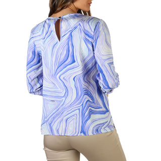 Woman’s blue and white patterned blouse.