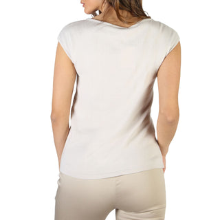 Woman’s beige top and pants.